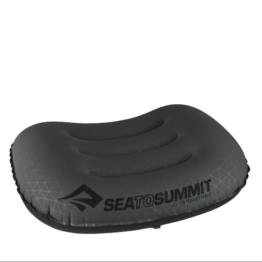 Ultra light gray hiking pillow with a textured surface, branded with 'Aeros UL Pillow' on the packed sack.
