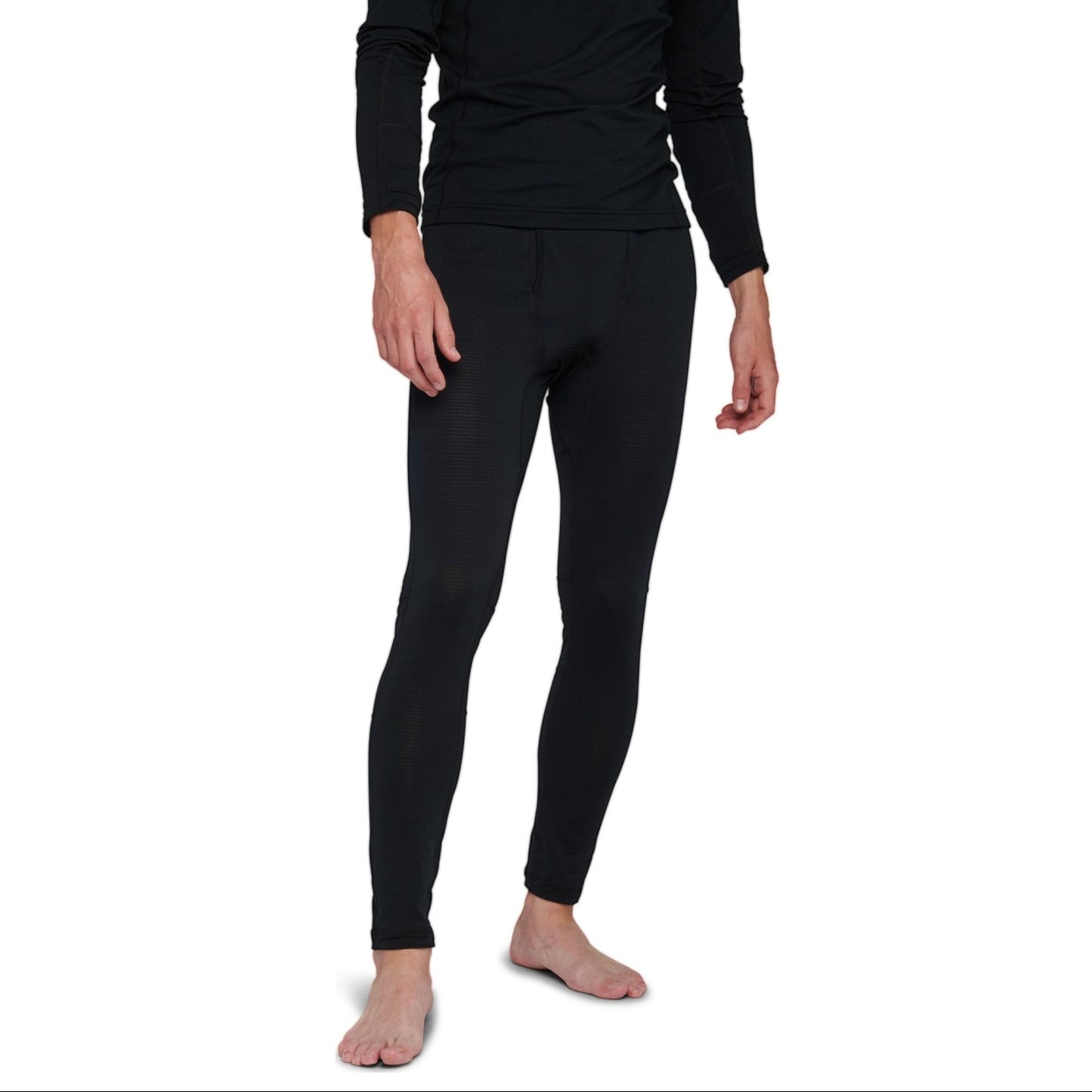 Person wearing black long-sleeve top and leggings on a white background