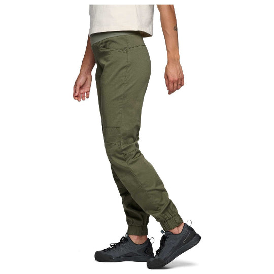 Person wearing olive green pants on a white background