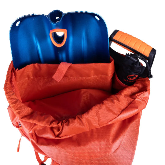 Orange backpack with a blue snow shovel and snow probe inside