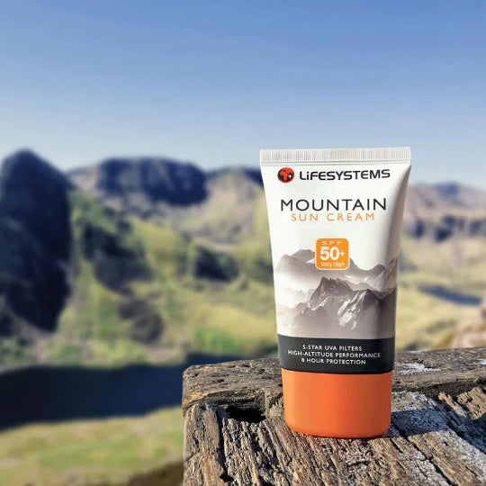 Tube of Lifesystems Mountain Sun Cream with mountain landscape in the background
