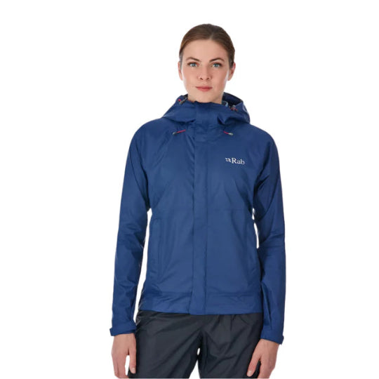 Woman wearing a blue raincoat with a visible brand logo on a white background