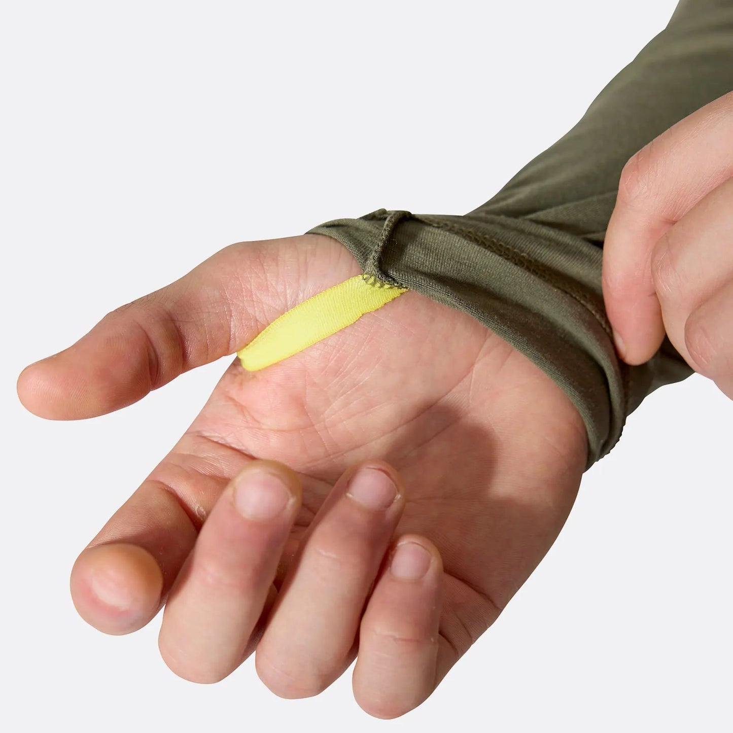 Hand wearing a green sleeve with a yellow thumb hole on a white background