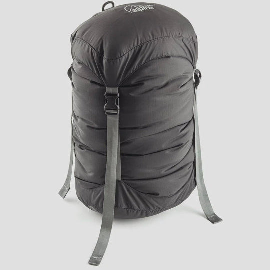 A gray nylon compression sack with four straps, a drawstring closure, and a D-ring hang loop.