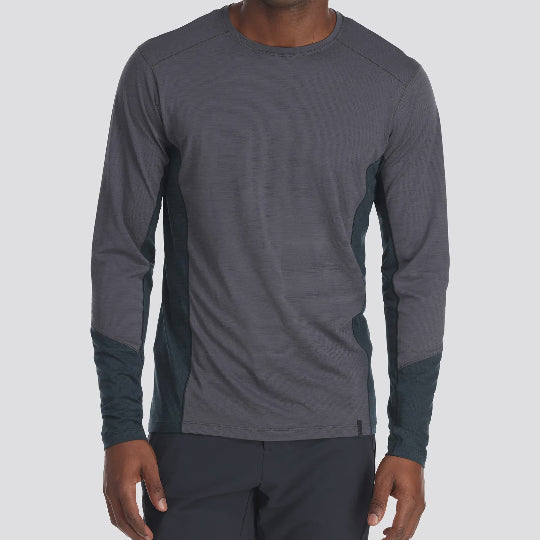Person wearing a gray long-sleeve athletic shirt on a light gray background