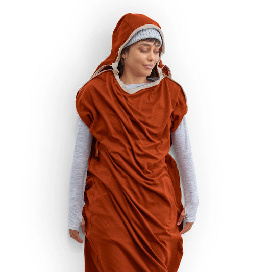 Person wearing a rust-colored robe over a light gray long-sleeve shirt on a white background