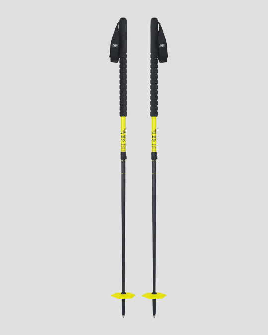Two black ski poles with yellow accents on a light gray background