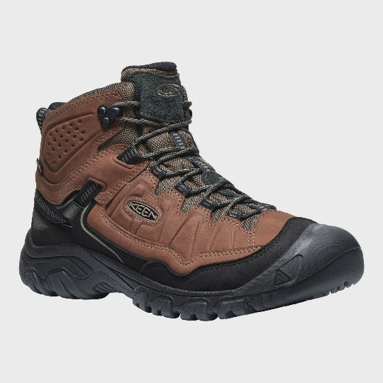 Brown hiking boot with black sole on a light gray background