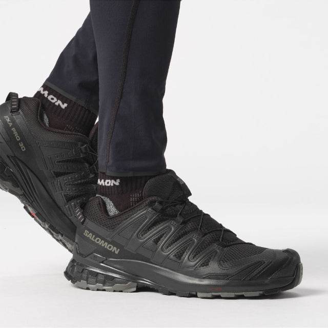 Black hiking shoes with visible brand logo on a white background