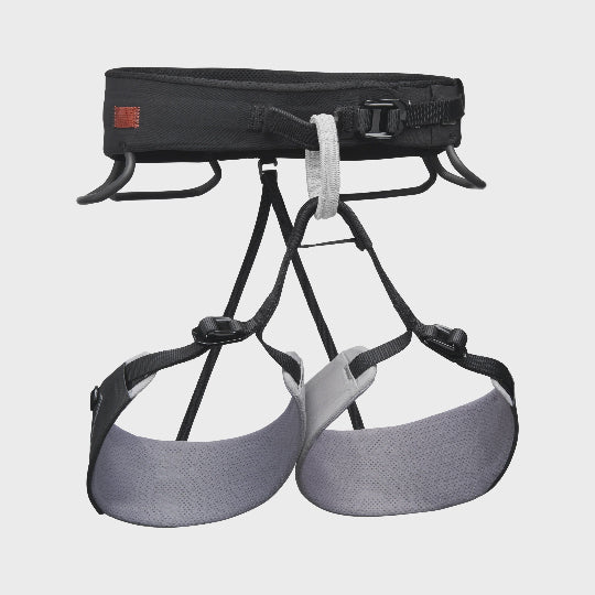 Climbing harness with black and gray straps on a light gray background