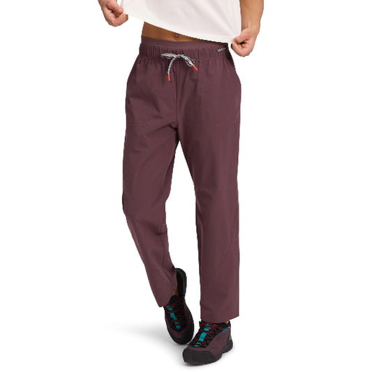Maroon pants worn by a person on a white background