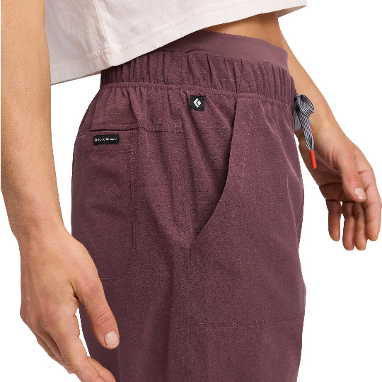 Maroon pants with Black Diamond logo worn by a person on a white background