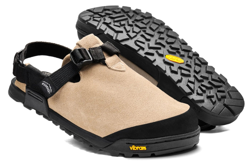 Beige clogs with black straps and sole on a white background
