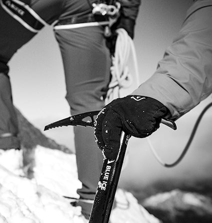 Person holding an ice axe with a blurred background