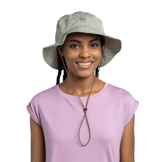 Woman wearing a gray bucket hat with a brand logo on a white background