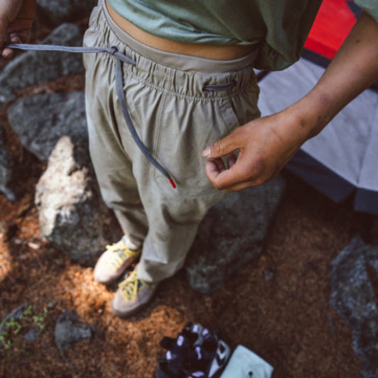 Person in outdoor setting with hiking gear on rocky ground