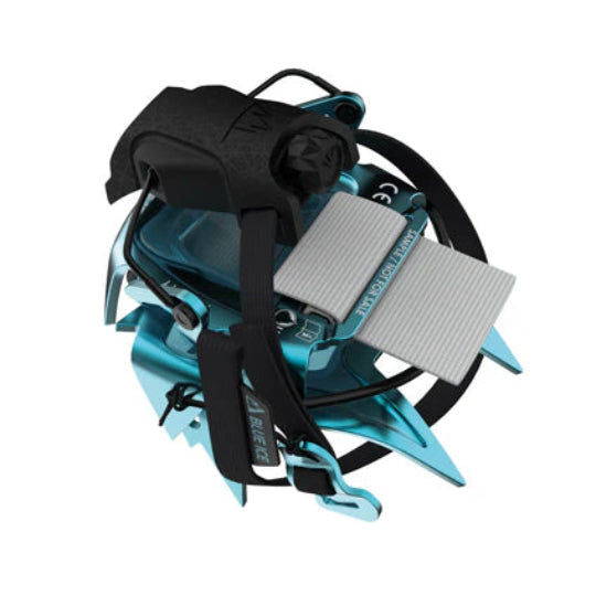 Turquoise crampon collapsed with black straps on a white background