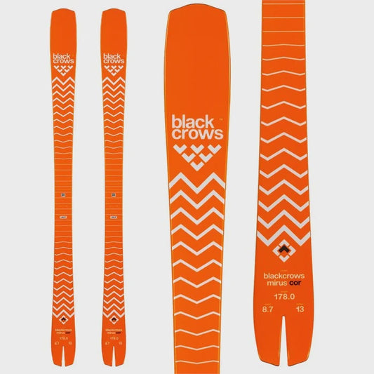 Orange skis with 'black crows' branding on a light gray background