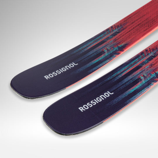 Two Rossignol skis with a colorful design on a light gray background