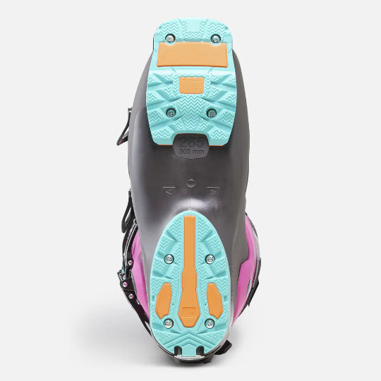 Close-up of a ski boot with teal and orange sole on a white background