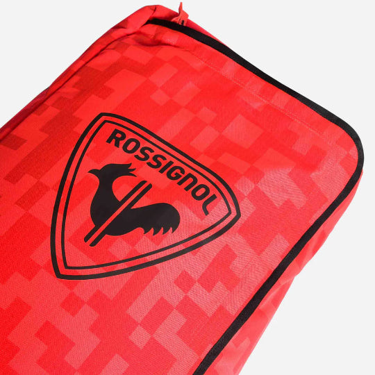 Red ski bag with a black Rossignol logo on a white background