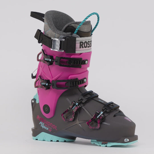 Pink and gray ski boot with visible branding on a white background