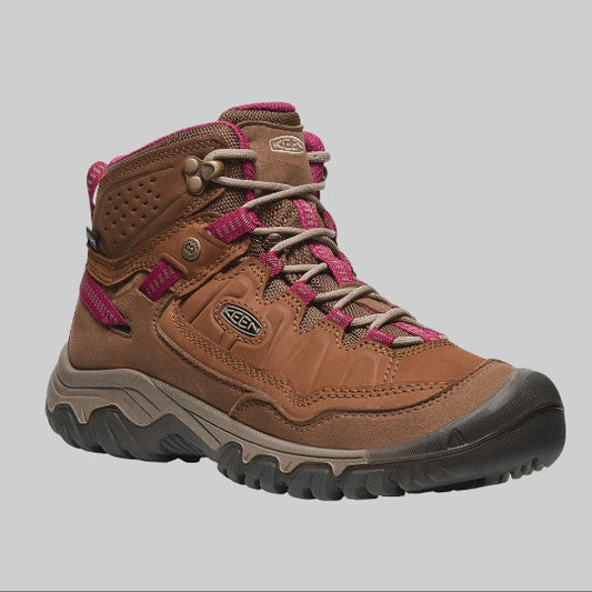 Brown hiking boot with pink accents on a gray background