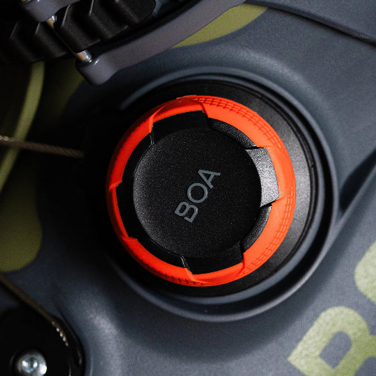 Close-up of a BOA system dial on a ski boot, with 'BOA' branding visible.