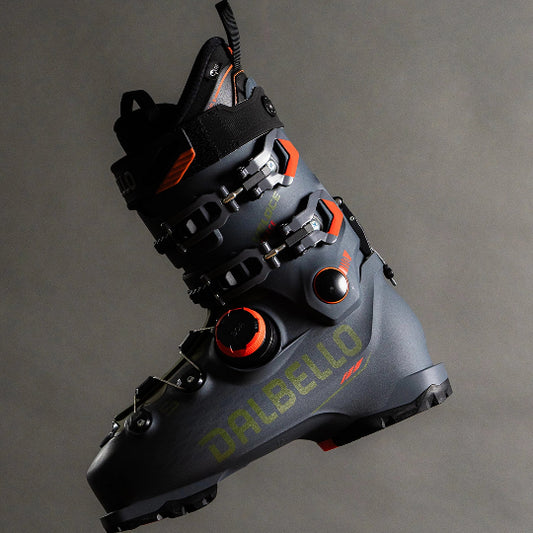 Gray ski boot with black and orange accents on a gray background