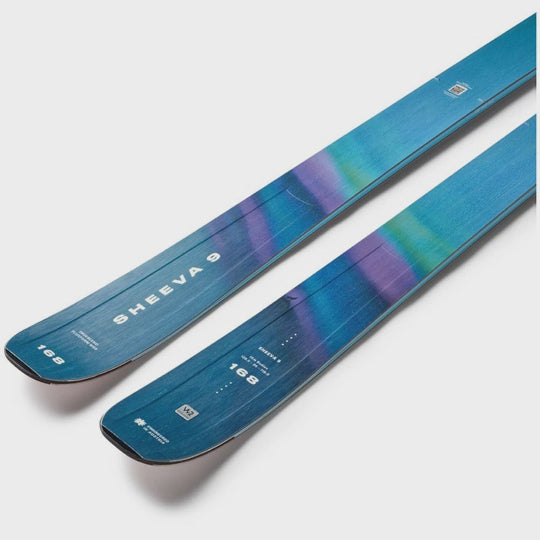 Two blue skis with a gradient design on a light gray background