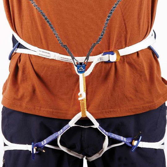 Person wearing a climbing harness on a white background