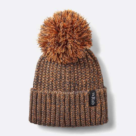Brown knit beanie with pom-pom on a white background