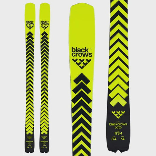 Yellow and black skis with 'black crows' branding on a white background