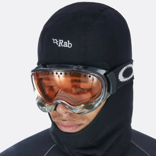 Person wearing a black Rab hood and goggles on a white background