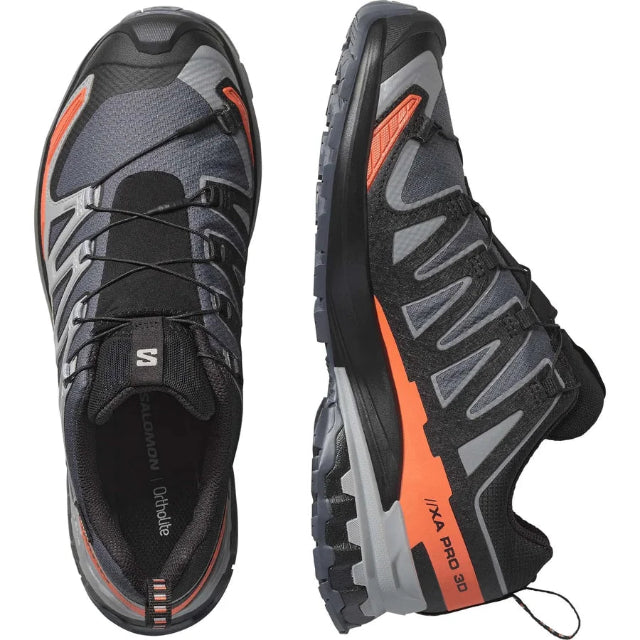 Black and gray running shoes with orange accents on a white background