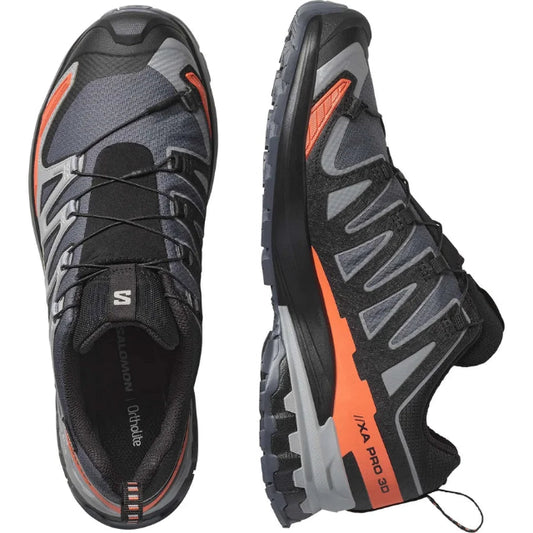 Black and gray running shoes with orange accents on a white background