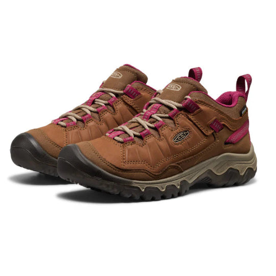 Brown hiking shoes with pink accents on a white background