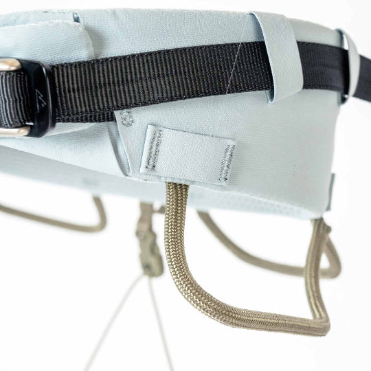 Close-up of a gray harness with black straps on a white background