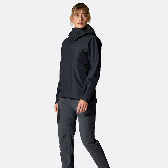 Person wearing a dark jacket and pants on a white background
