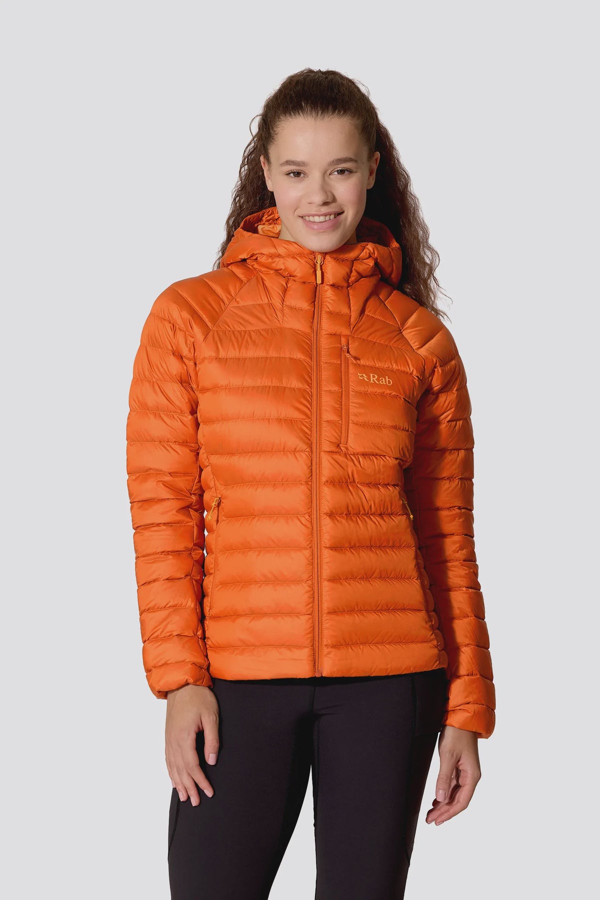 Woman wearing an orange down puffer jacket